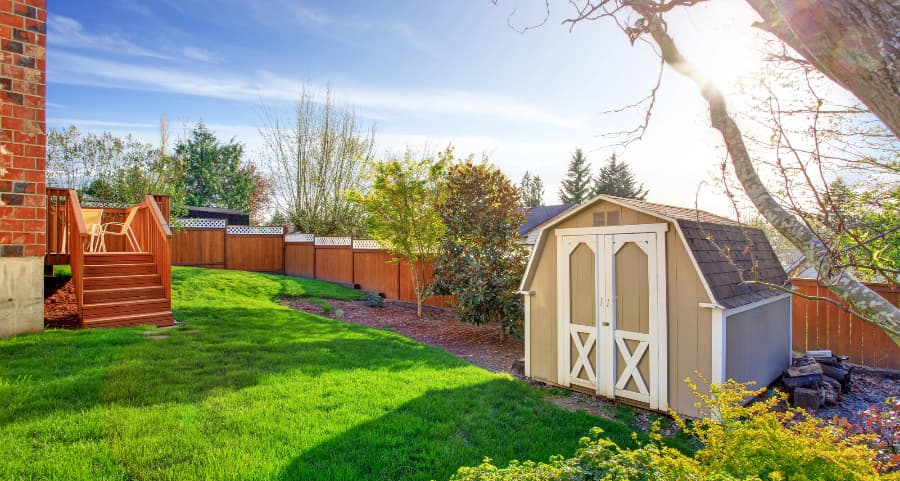 Fenced backyard with storage shed in Hoover